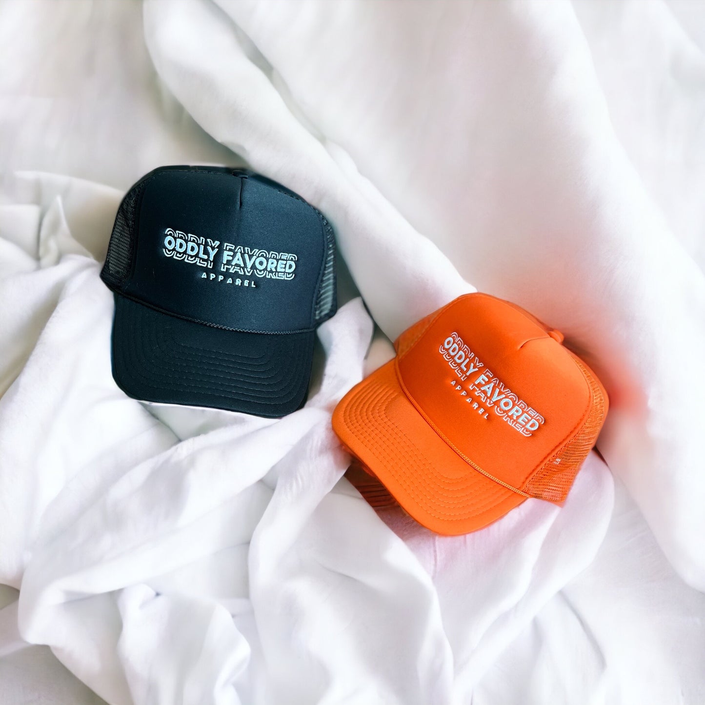 Embroidered Oddly Favored Logo Trucker Hat